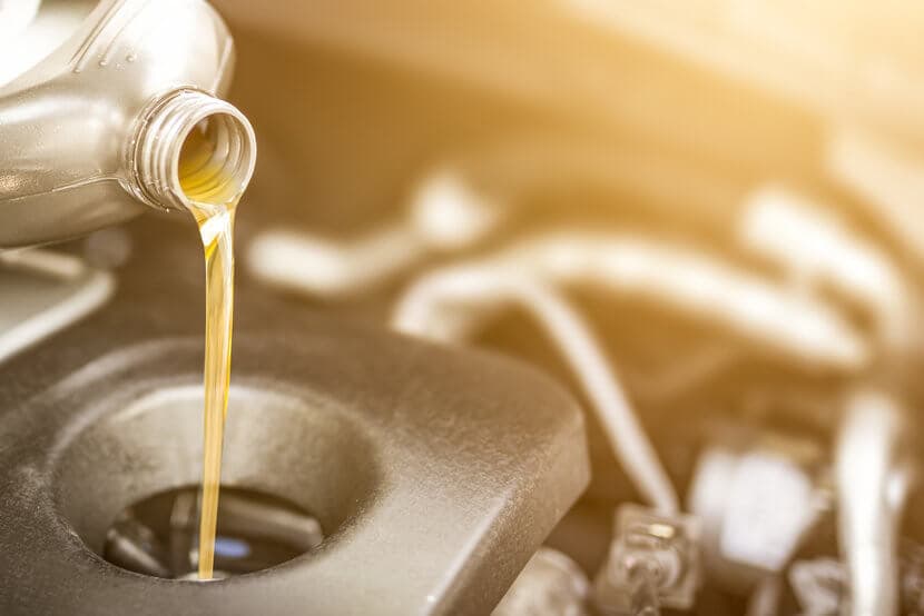 Fresh motor oil being poured into car